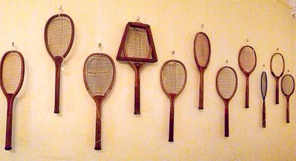 Tennis rackets mounted on a wall.